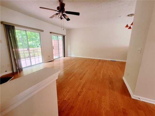 523 Lantern Wood Dr, Scottdale, GA 30079 - spare room featuring baseboards, ceiling fan, and light wood-style flooring