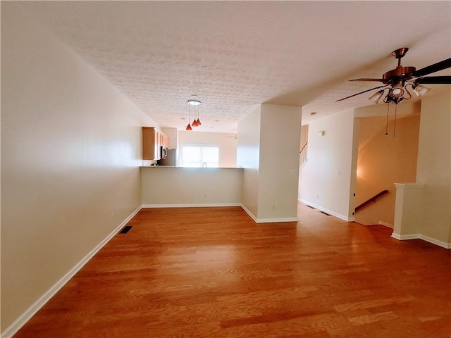 523 Lantern Wood Dr, Scottdale, GA 30079 - spare room featuring a ceiling fan, a textured ceiling, visible vents, baseboards, and light wood-style flooring