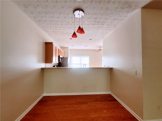 523 Lantern Wood Dr, Scottdale, GA 30079 - unfurnished room with baseboards, a sink, and dark wood-style flooring
