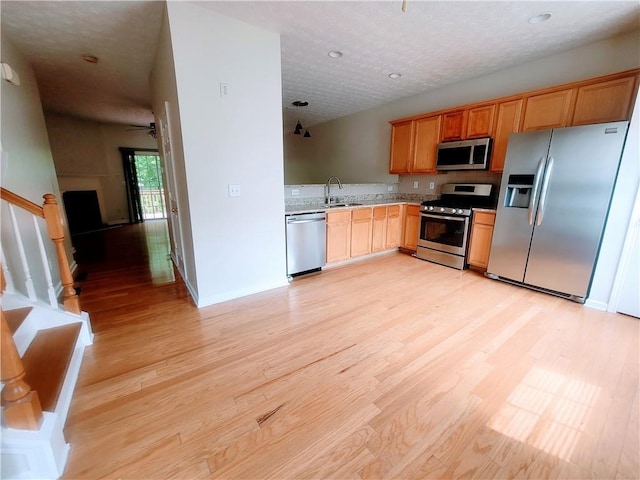 523 Lantern Wood Dr, Scottdale, GA 30079 - kitchen with a ceiling fan, light wood-type flooring, a sink, light countertops, and stainless steel appliances