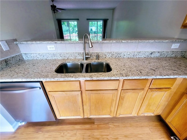 523 Lantern Wood Dr, Scottdale, GA 30079 - kitchen with a sink, light stone counters, light wood-style floors, and dishwasher