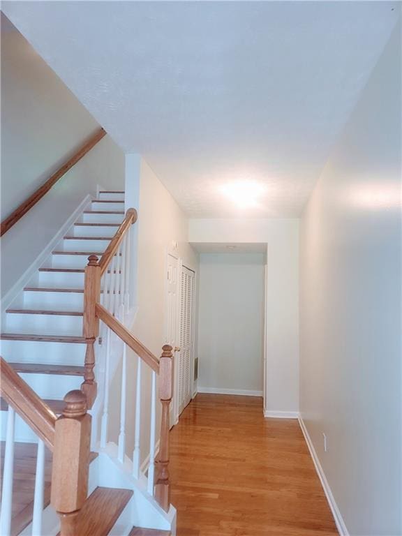 523 Lantern Wood Dr, Scottdale, GA 30079 - staircase with baseboards and wood finished floors
