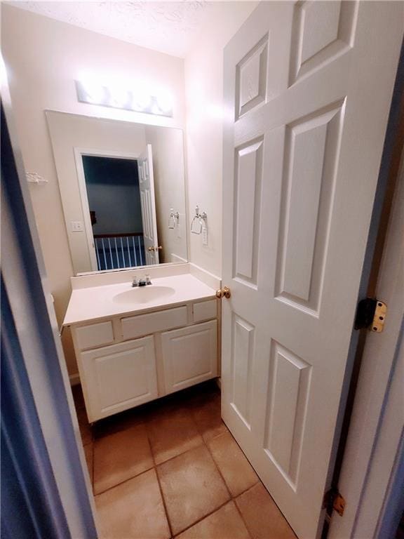 523 Lantern Wood Dr, Scottdale, GA 30079 - bathroom featuring vanity, a textured ceiling, and tile patterned flooring