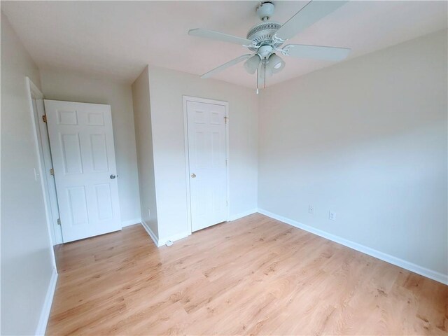 523 Lantern Wood Dr, Scottdale, GA 30079 - unfurnished bedroom featuring a ceiling fan, baseboards, and light wood-type flooring