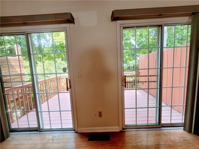 523 Lantern Wood Dr, Scottdale, GA 30079 - doorway to outside featuring baseboards, plenty of natural light, and wood finished floors