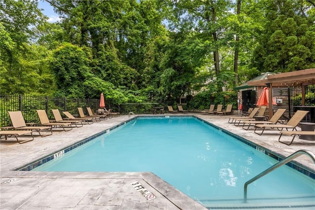 3235 Roswell Rd NE Unit 702, Atlanta, GA 30305 - community pool featuring a patio and view of scattered trees