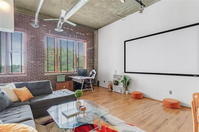 3235 Roswell Rd NE Unit 702, Atlanta, GA 30305 - home theater room with brick wall, wood finished floors, and ceiling fan