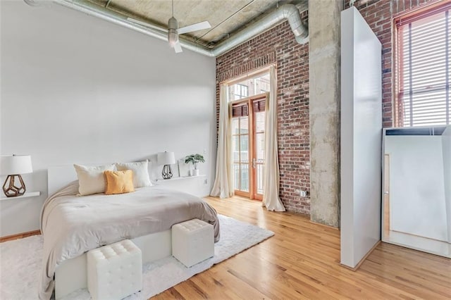 3235 Roswell Rd NE Unit 702, Atlanta, GA 30305 - bedroom with brick wall, wood finished floors, a high ceiling, and access to outside