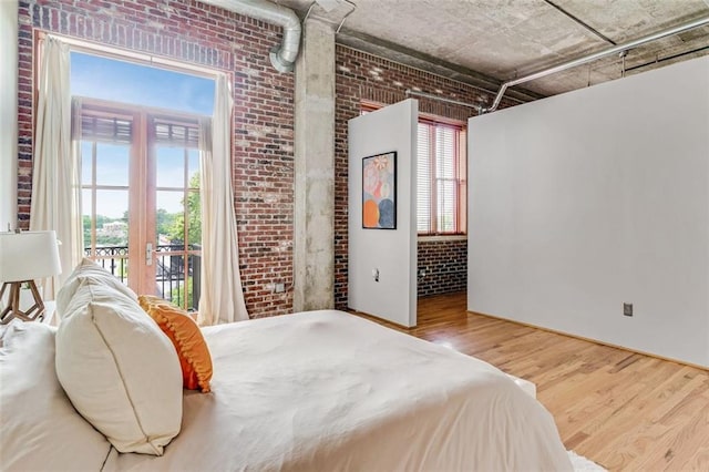 3235 Roswell Rd NE Unit 702, Atlanta, GA 30305 - bedroom with brick wall, wood finished floors, access to exterior, and french doors