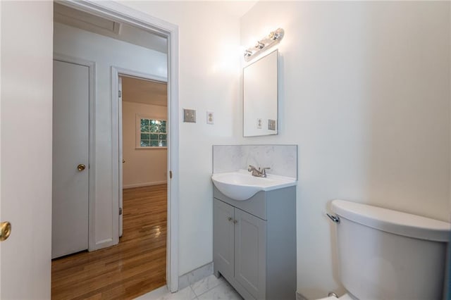 half bath featuring toilet and vanity