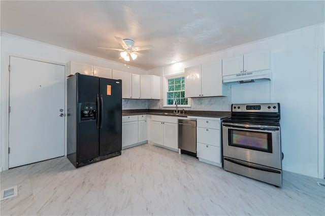 kitchen featuring visible vents, dark countertops, appliances with stainless steel finishes, marble finish floor, and under cabinet range hood