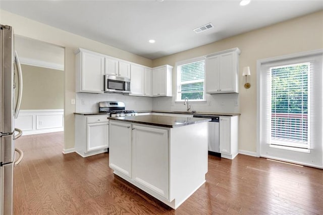 213 Roseman Way, Woodstock, GA 30188 - kitchen featuring appliances with stainless steel finishes, dark countertops, dark wood-style flooring, white cabinets, and recessed lighting