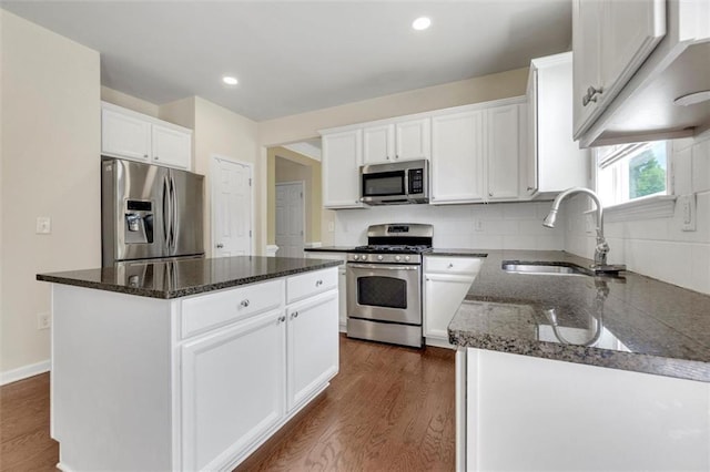 213 Roseman Way, Woodstock, GA 30188 - kitchen with appliances with stainless steel finishes, dark stone counters, dark wood-type flooring, white cabinets, and recessed lighting