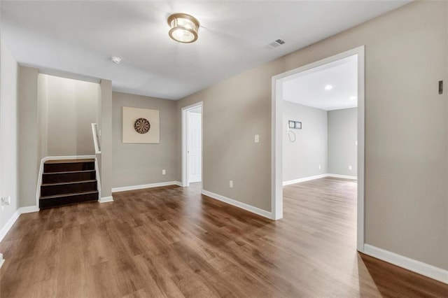 213 Roseman Way, Woodstock, GA 30188 - empty room featuring wood finished floors, stairs, and a smoke detector