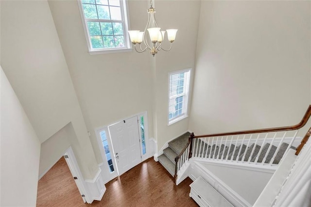 213 Roseman Way, Woodstock, GA 30188 - entrance foyer featuring a chandelier, a high ceiling, wood finished floors, and stairway