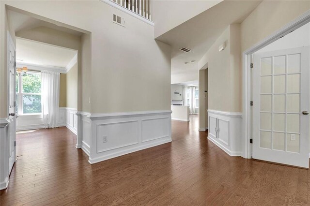 213 Roseman Way, Woodstock, GA 30188 - corridor featuring dark wood-style floors, a wainscoted wall, and a decorative wall