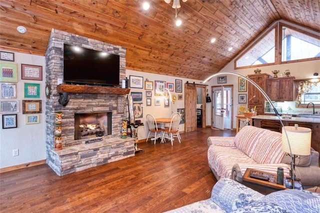 living room featuring dark hardwood / wood-style flooring, a stone fireplace, wooden ceiling, and sink