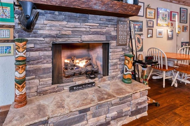 room details featuring hardwood / wood-style flooring and a stone fireplace