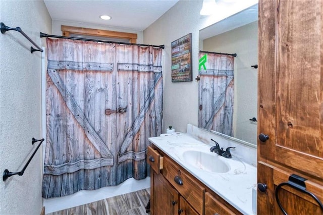 bathroom with curtained shower and vanity