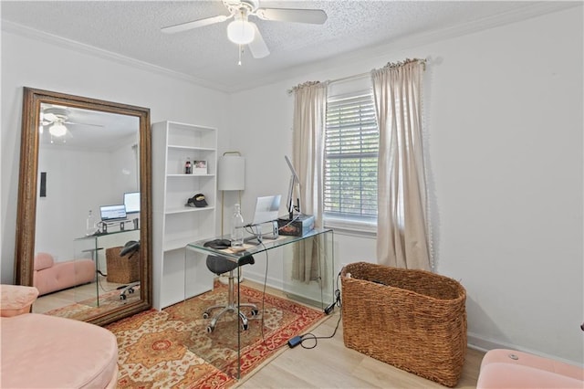 office area with ceiling fan, a textured ceiling, ornamental molding, wood finished floors, and baseboards