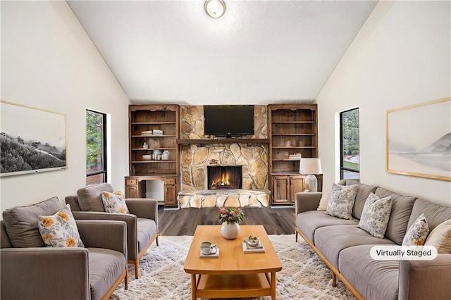 living room with a fireplace, dark hardwood / wood-style floors, and high vaulted ceiling