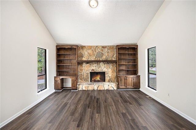 unfurnished living room with a fireplace, high vaulted ceiling, a textured ceiling, and dark hardwood / wood-style flooring