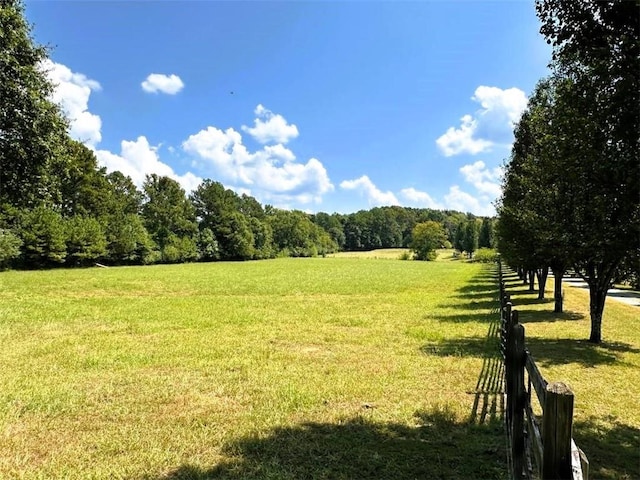 surrounding community featuring a yard and a rural view