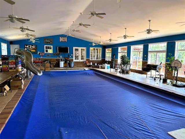 view of swimming pool featuring ceiling fan and a water slide