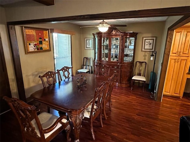 dining space with ceiling fan and dark hardwood / wood-style flooring