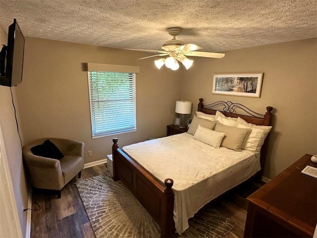 bedroom with a textured ceiling, ceiling fan, and dark hardwood / wood-style floors