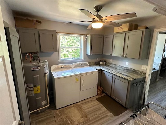 laundry area with light hardwood / wood-style flooring, independent washer and dryer, ceiling fan, cabinets, and water heater