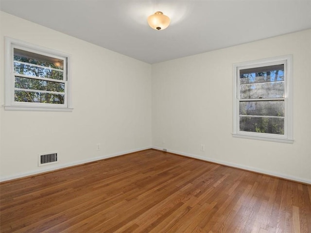 spare room with hardwood / wood-style flooring