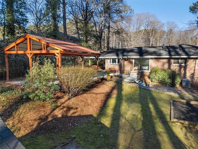 view of yard featuring a gazebo and central AC unit