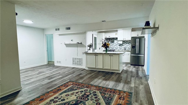 kitchen with visible vents, decorative backsplash, and stainless steel refrigerator with ice dispenser
