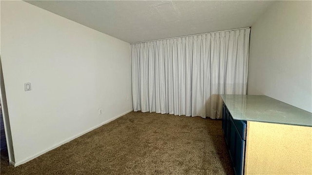 empty room featuring dark carpet