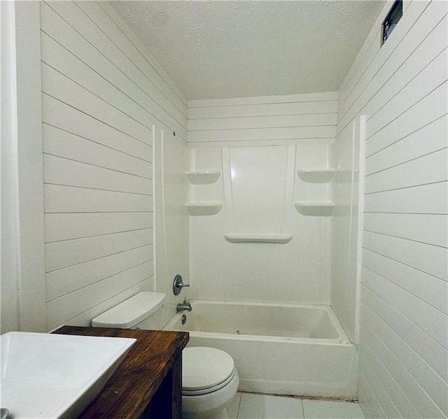 full bath featuring a textured ceiling, vanity, toilet, tile patterned floors, and wooden walls