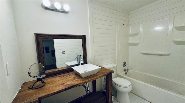 bathroom featuring a sink, toilet, and  shower combination