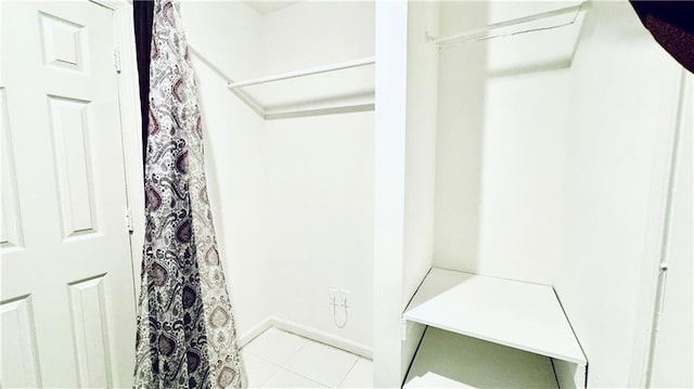 walk in closet featuring tile patterned flooring