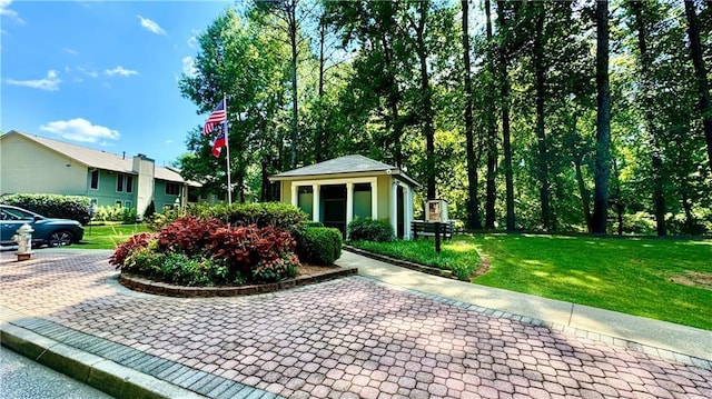 view of community featuring an outdoor structure and a lawn