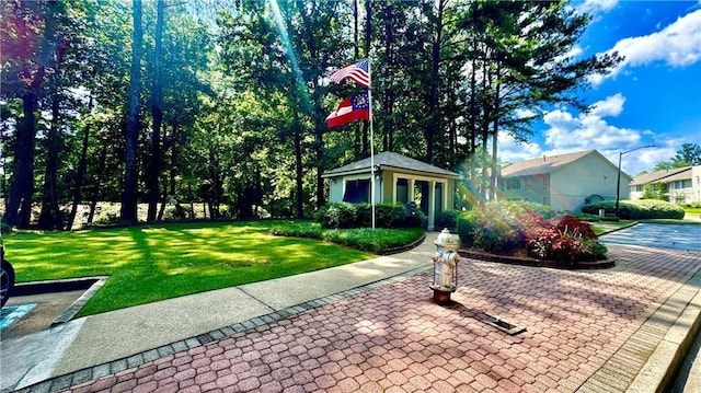 view of front facade with a front yard and an outbuilding