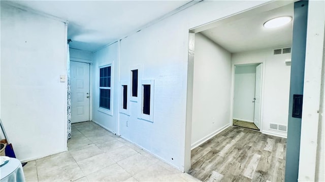 corridor featuring visible vents and wood finished floors