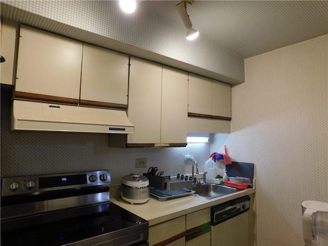 kitchen featuring white cabinets, appliances with stainless steel finishes, and sink