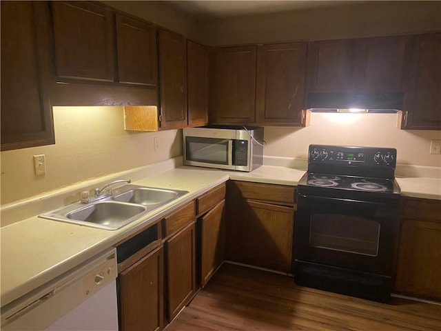 kitchen featuring dark hardwood / wood-style flooring, black electric range, sink, and white dishwasher