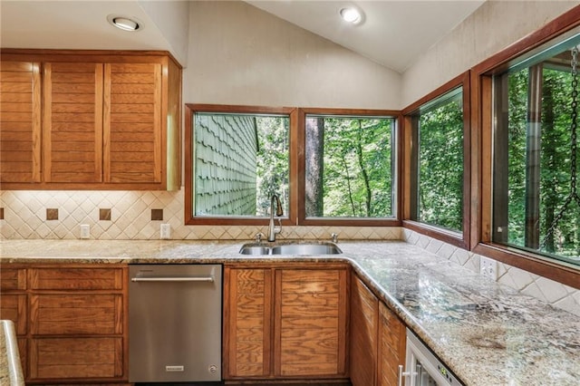 562 Pine Valley Rd SE, Marietta, GA 30067 - kitchen featuring stainless steel dishwasher, lofted ceiling, tasteful backsplash, light stone counters, and brown cabinets