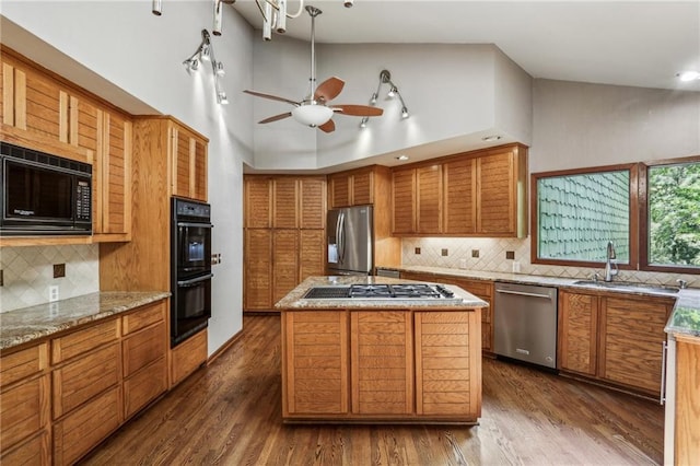 562 Pine Valley Rd SE, Marietta, GA 30067 - kitchen featuring black appliances, high vaulted ceiling, brown cabinetry, tasteful backsplash, and a ceiling fan