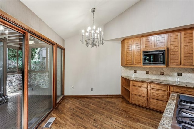 562 Pine Valley Rd SE, Marietta, GA 30067 - kitchen with black microwave, vaulted ceiling, dark wood-style floors, tasteful backsplash, and a chandelier