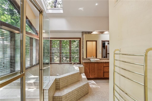562 Pine Valley Rd SE, Marietta, GA 30067 - bathroom with vanity, plenty of natural light, a bath, and a skylight