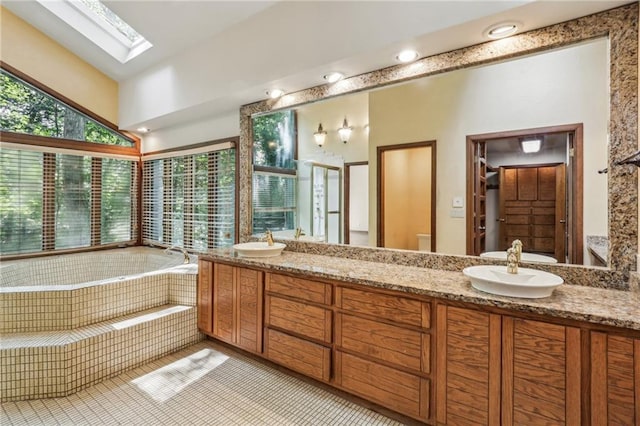562 Pine Valley Rd SE, Marietta, GA 30067 - bathroom featuring a skylight, double vanity, a garden tub, and tile patterned flooring