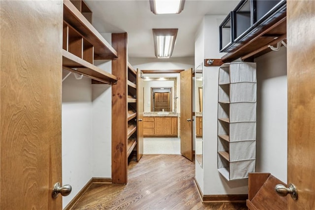 562 Pine Valley Rd SE, Marietta, GA 30067 - walk in closet with wood finished floors