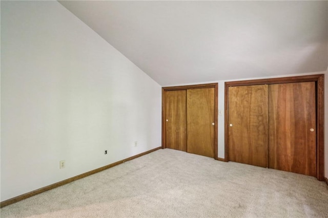 562 Pine Valley Rd SE, Marietta, GA 30067 - unfurnished bedroom with carpet floors, two closets, and lofted ceiling